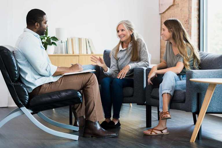 Family counselor talking to mom and daughter