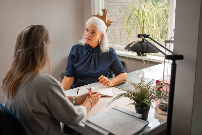 Forensic psychologist speaking to client at desk