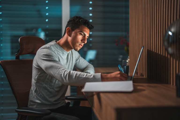 Forensic psychology doctoral student studying on laptop