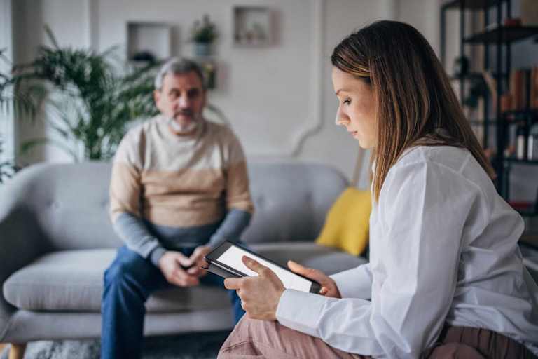 Psychologist using tablet in session with patient