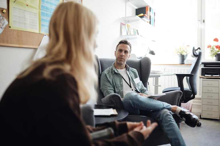 School psychologist helping student in office