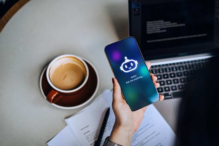 Person using AI chat bot on phone at desk